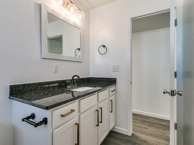 bathroom with vanity and wood-type flooring