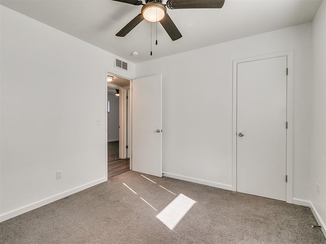 unfurnished bedroom featuring ceiling fan and carpet floors