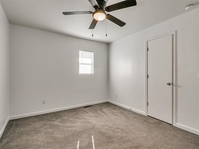 empty room with ceiling fan and carpet floors