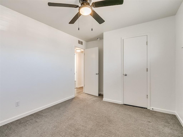 unfurnished bedroom featuring ceiling fan and light colored carpet