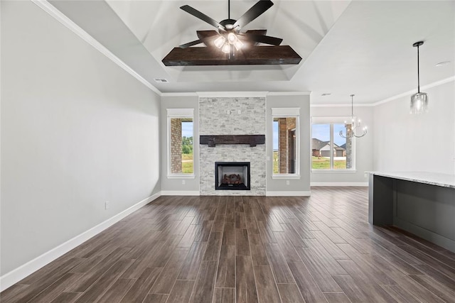 unfurnished living room featuring beamed ceiling, ceiling fan with notable chandelier, a stone fireplace, and crown molding