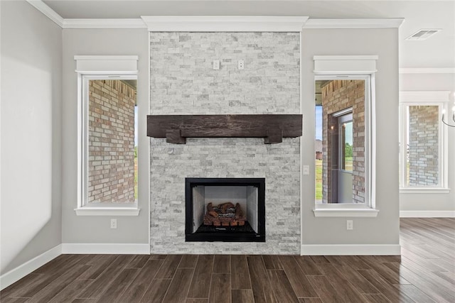 unfurnished living room featuring crown molding and a fireplace