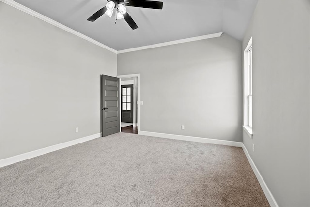 spare room with carpet flooring, ceiling fan, lofted ceiling, and ornamental molding