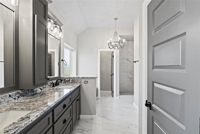 bathroom featuring vanity, an inviting chandelier, and vaulted ceiling