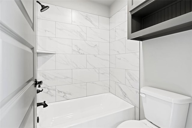 bathroom with tiled shower / bath combo and toilet