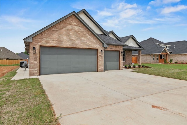 10513 SW 51st St, Mustang, OK 73064 - view of front of home with brick siding, a garage, and driveway