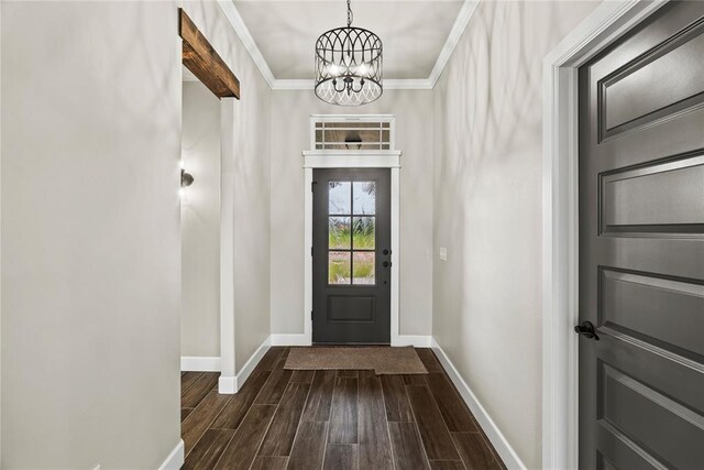 10513 SW 51st St, Mustang, OK 73064 - entryway with a chandelier, baseboards, dark wood-style flooring, and crown molding