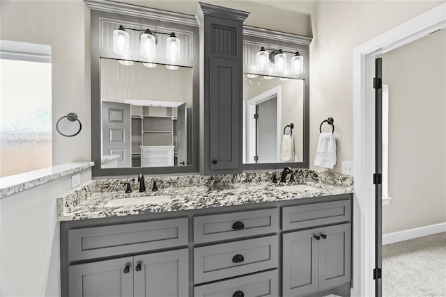 10513 SW 51st St, Mustang, OK 73064 - bathroom featuring double vanity and baseboards