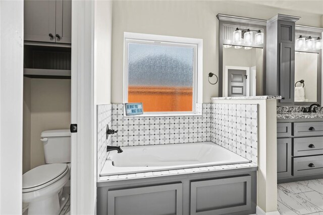 10513 SW 51st St, Mustang, OK 73064 - full bath with vanity, a bath, toilet, and marble look tile flooring