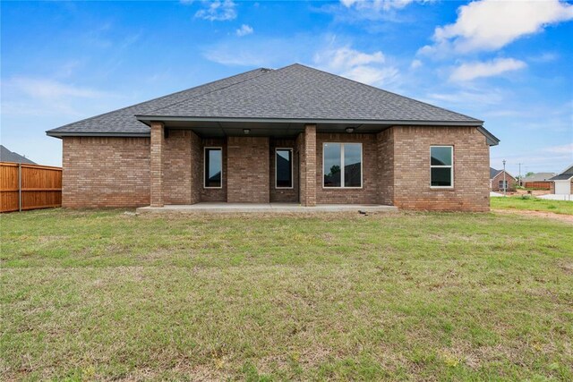 10513 SW 51st St, Mustang, OK 73064 - back of house featuring roof with shingles, brick siding, and a patio