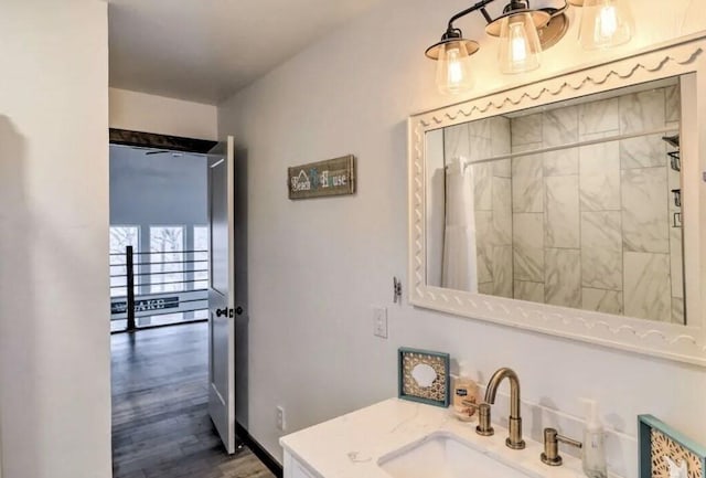 bathroom featuring hardwood / wood-style flooring, vanity, and curtained shower