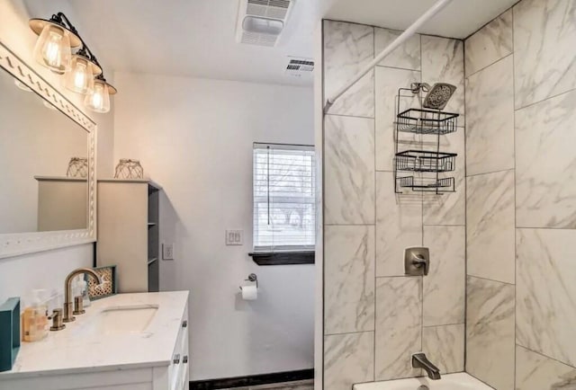 bathroom with vanity and tiled shower / bath