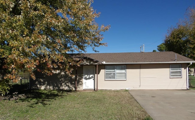 104 Gatewood Dr, Chickasha, OK 73018 - view of front of house featuring a front yard, concrete driveway, and roof with shingles