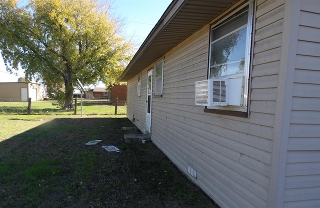 view of property exterior featuring a lawn and cooling unit