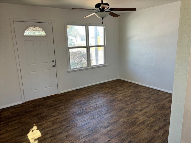 foyer entrance with dark wood-style floors, baseboards, and a ceiling fan