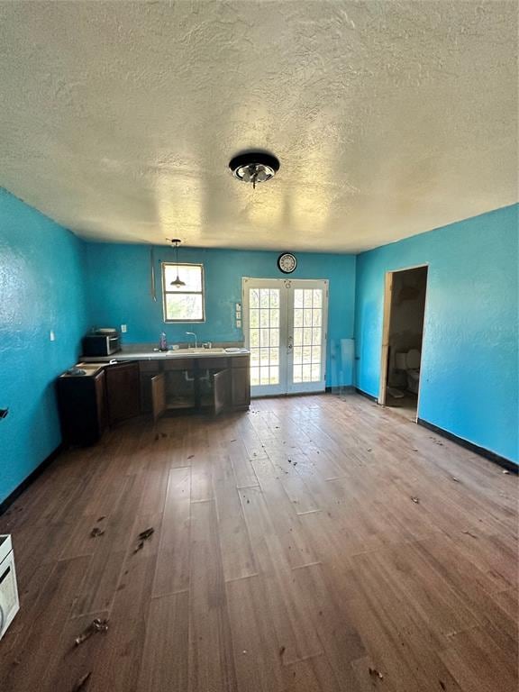 interior space featuring french doors, hardwood / wood-style floors, a textured ceiling, and sink