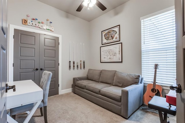 carpeted home office with ceiling fan