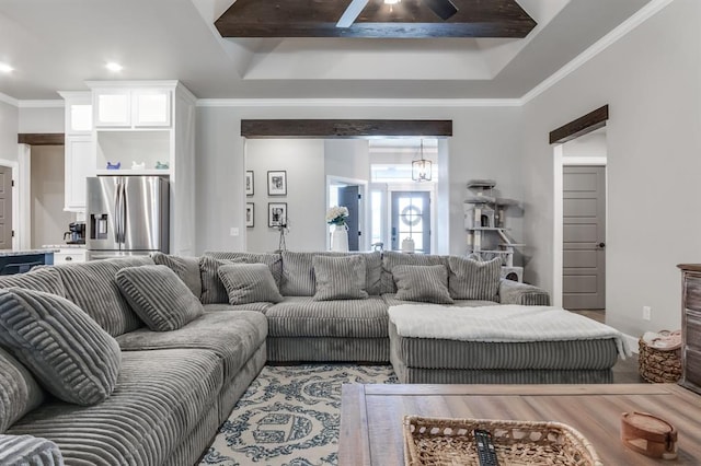 living room featuring beam ceiling, crown molding, and a tray ceiling