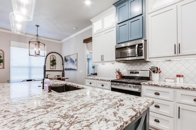 kitchen with sink, stainless steel appliances, backsplash, decorative light fixtures, and white cabinets