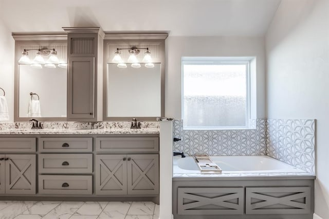 bathroom with a bathing tub, vanity, and vaulted ceiling