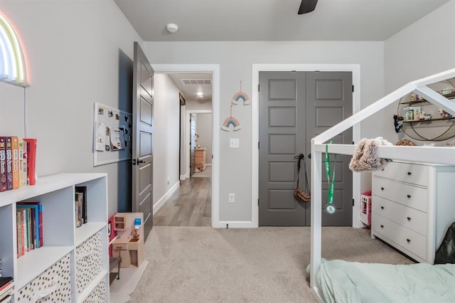 bedroom with ceiling fan and light colored carpet