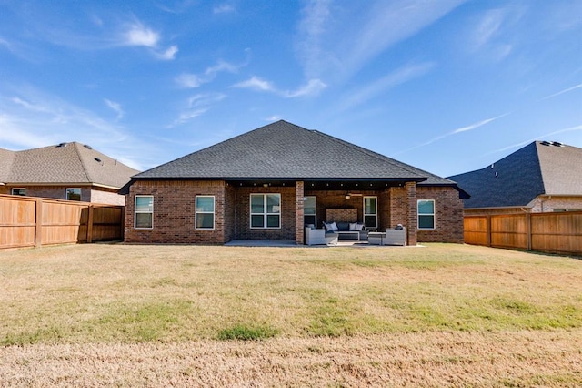 rear view of house featuring outdoor lounge area, a patio, and a lawn