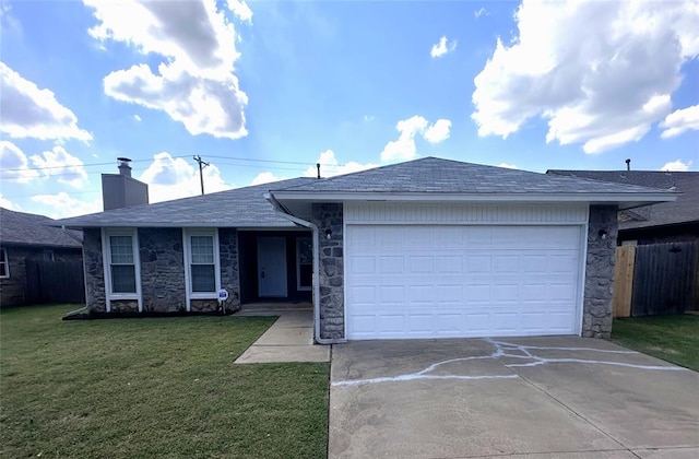 single story home with a garage and a front lawn