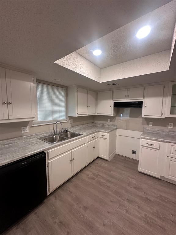 kitchen with white cabinets, a textured ceiling, sink, hardwood / wood-style flooring, and dishwasher