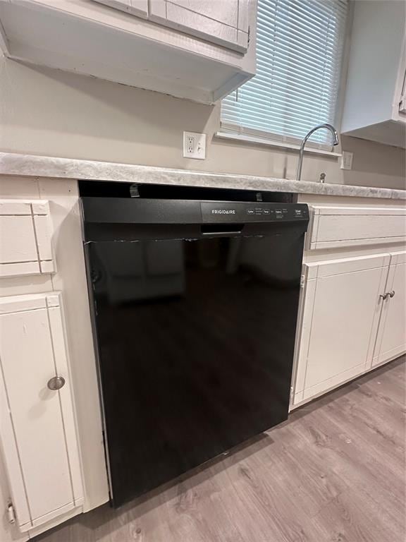 kitchen featuring white cabinetry, light hardwood / wood-style flooring, dishwasher, and sink