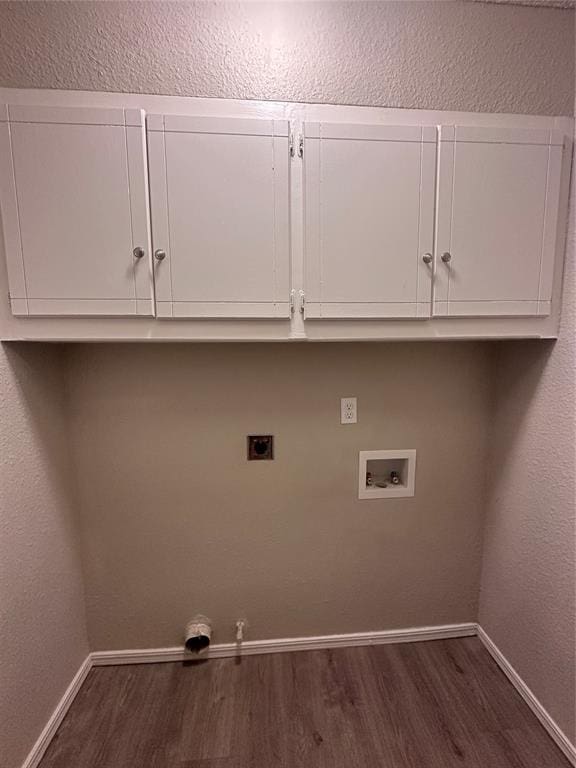 laundry room with cabinets, washer hookup, electric dryer hookup, dark hardwood / wood-style floors, and hookup for a gas dryer