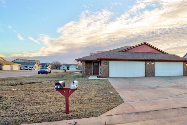 ranch-style house with a yard and a garage