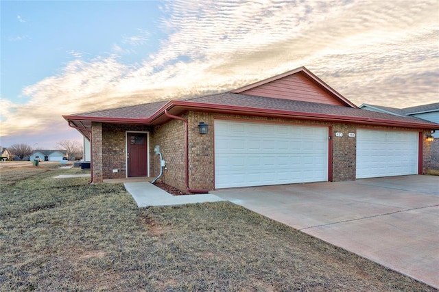 single story home with a lawn and a garage