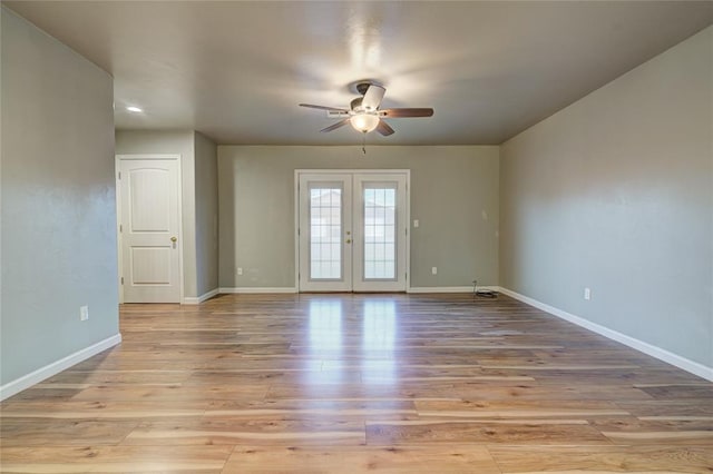 empty room featuring french doors, light hardwood / wood-style flooring, and ceiling fan