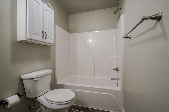 bathroom featuring tile patterned floors, shower / bath combination, and toilet