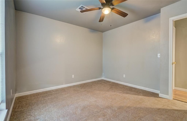 spare room featuring carpet flooring and ceiling fan