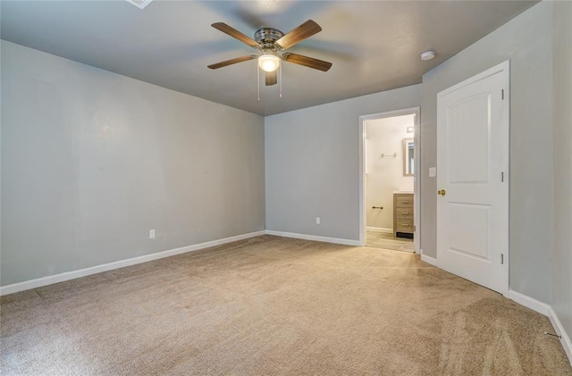 unfurnished bedroom with light carpet, connected bathroom, and ceiling fan