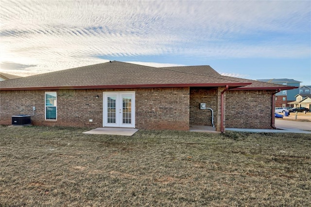 back of house with french doors, central AC, and a lawn