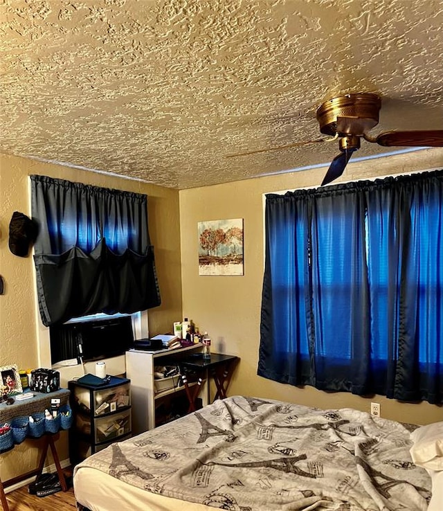 bedroom featuring hardwood / wood-style floors and a textured ceiling