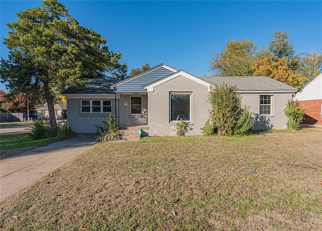 ranch-style home with a front lawn