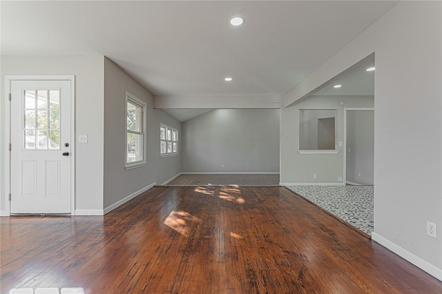 unfurnished living room featuring dark wood-type flooring