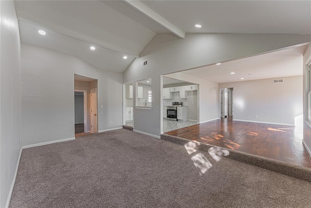 unfurnished living room with lofted ceiling with beams and wood-type flooring