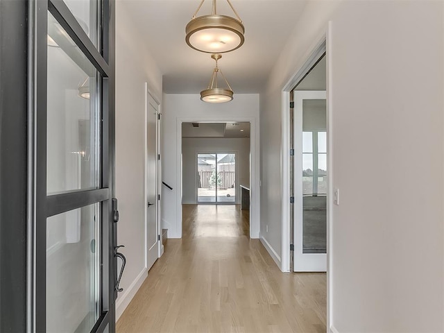 corridor with light hardwood / wood-style floors