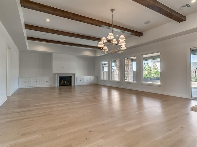 unfurnished living room featuring light hardwood / wood-style flooring, beamed ceiling, and a chandelier