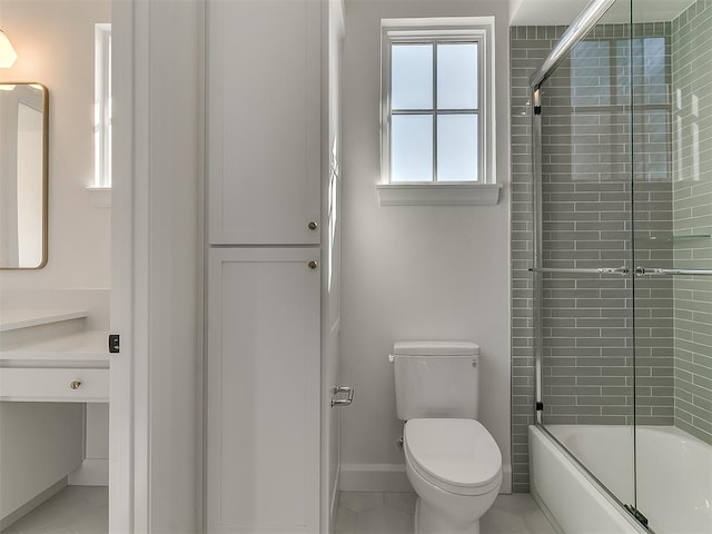 full bathroom featuring vanity, bath / shower combo with glass door, and toilet