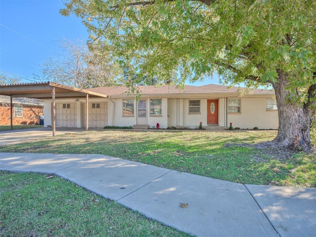 ranch-style home featuring a front yard and a carport