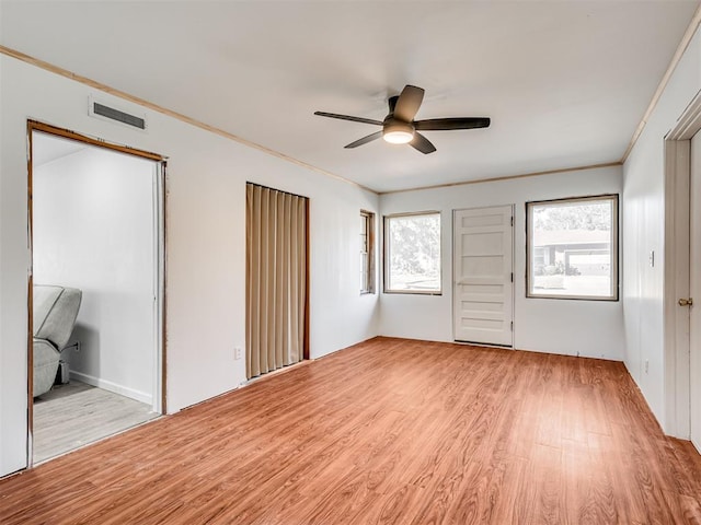 unfurnished bedroom with ceiling fan, light hardwood / wood-style floors, and ornamental molding