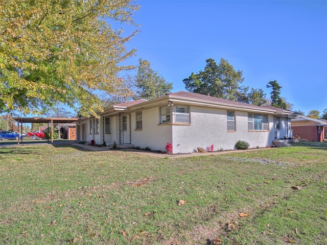 ranch-style house with a carport and a front yard