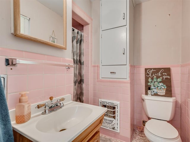 bathroom with vanity and tile walls