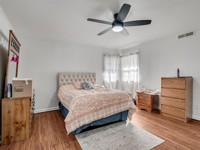 bedroom with hardwood / wood-style floors and ceiling fan