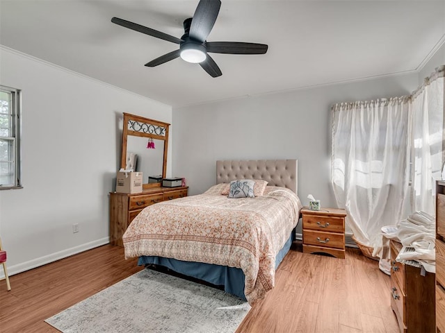 bedroom with ceiling fan, light wood-type flooring, and ornamental molding